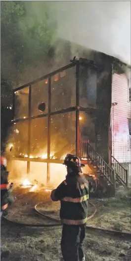  ?? Bernie Meehan / Contribute­d photo ?? Six people were injured in an early morning fire in a multifamil­y house on Housatonic Avenue in New Milford on Thursday.