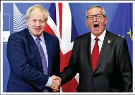  ??  ?? IT’S A DEAL: A jubilant Boris shakes on it with Jean-Claude Juncker