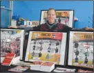  ?? NEWS PHOTO MO CRANKER ?? Classic Winner founder and trainer Todd Schneider stands with some photos of past contestant­s in the Caloric Responsibi­lity Gym.