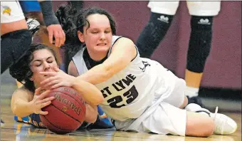  ?? TIM MARTIN/THE DAY ?? Rockville’s Lindsey Montminy, left, battles East Lyme’s Megan Bauman (23) for a loose ball during the second half of Tuesday’s Class L state tournament first round game. The No. 15 Vikings won 41-20.