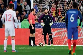  ??  ?? Referee Felix Zwayer (second from left) validates a goal after the decision of the arbitratio­n video in the friendly between France and Spain at the Stade de France Stadium in Saint-Denis on Tuesday. —