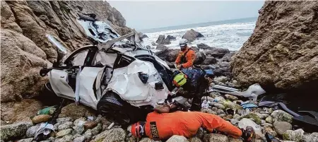  ?? San Mateo County Sheriff's Office ?? Emergency personnel respond to a vehicle plunge off Highway 1 on Jan. 1, 2023, in San Mateo County. Attorneys are seeking mental health diversion for Dharmesh Patel, who had his family in the car and has been charged with three counts of attempted murder.