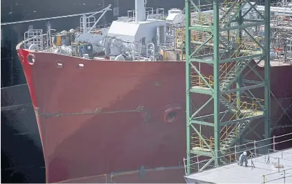  ?? REUTERS ?? A worker labours near a ship under constructi­on at Hyundai Heavy Industries’ shipyard in Ulsan, South Korea. The separation into four firms will pave the way for new deals.