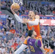  ??  ?? Thunder guard Russell Westbrook goes up for a basket.