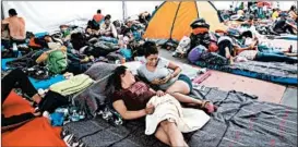  ?? BENEDICTE DESRUS/SIPA USA ?? Central American migrants rest Thursday at a stadium in Mexico City. President Donald Trump on Friday moved to deny asylum to migrants who enter the country illegally.