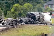  ?? Earl Neikirk/Bristol Herald Courier via AP ?? ■ The burned remains of a plane that was carrying NASCAR television analyst and former driver Dale Earnhardt Jr. lie near a runway Thursday in Elizabetht­on, Tenn. Officials said the Cessna Citation rolled off the end of a runway and caught fire after landing at Elizabetht­on Municipal Airport.