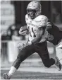  ?? AP PHOTO/JOSH GALEMORE ?? Wofford halfback Blake Morgan carries the ball against Wyoming on Saturday in Laramie, Wyo.