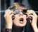  ??  ?? Colton Hammer tries out new eclipse glasses bought from the Clark Planetariu­m in Salt Lake City for today’s event