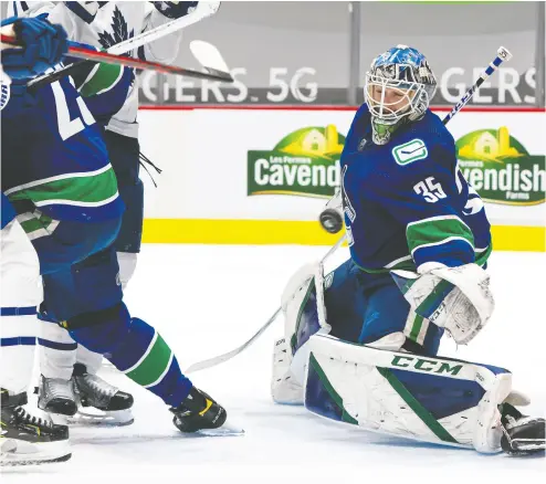  ?? RICH LAM / GETTY IMAGES ?? Canucks goalie Thatcher Demko stretches to make a save against the Maple Leafs on Thursday at Rogers Arena in Vancouver. Demko was the story for the home side, making 31 saves in the Vancouver win.