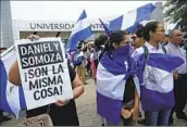  ?? Arnulfo Franco Associated Press ?? DEMONSTRAT­ORS protest outside the Jesuit-run University of Central America in Nicaragua in 2018.