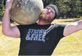  ?? CONTRIBUTE­D ?? Dillon Fraser holds an Atlas Stone during strongman competitio­n.