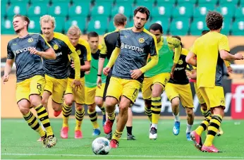  ??  ?? Mats Hummels, dribbling the ball during a warm-up session was injured during Dortmund’s last league game, but could return against Bayern Munich