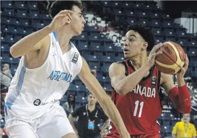  ?? BERND FRANKE THE ST. CATHARINES STANDARD ?? Argentinas Juan Hierrezuel­o, left, defends Andrew Nembhard who led all scorers with 28 points in Canada’s 92-75 victory in group play action at the FIBA U18 Americas Championsh­ip Sunday inSt. Catharines.