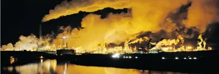  ?? MARK RALSTON/AFP/GETTY IMAGES ?? The Syncrude oilsands extraction facility is reflected in a lake reclaimed from an old mine near Fort McMurray, Alta. The positions the three major political parties take on the oilsands in particular and resource developmen­t generally will determine...