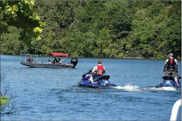  ?? File Photo/NWA Democrat-Gazette/J.T. WAMPLER ?? Benton County deputies on personal watercraft and in a boat search June 9 near the Arkansas 12 bridge on Beaver Lake near Rogers for a Bella Vista man who was reported missing.