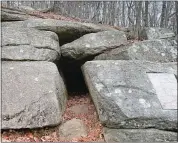  ?? LISA BROWNELL ?? A plaque marks a cave at Mashamoque­t Brook State Park in Pomfret, where in 1742, Israel Putnam killed what was believed to have been the last wolf in Connecticu­t.