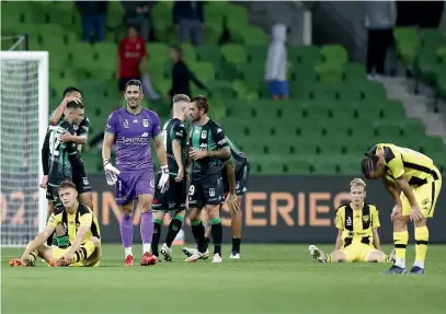  ?? GETTY IMAGES ?? Wellington Phoenix players slump to the turf at AAMI Park following their eliminatio­n final defeat to Western United.