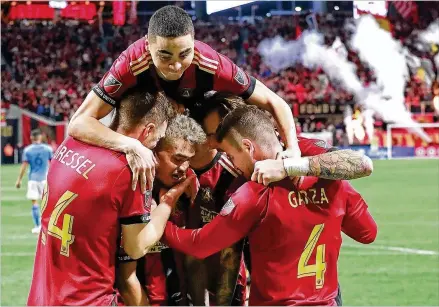  ?? CURTIS COMPTON / CCOMPTON@AJC.COM ?? Atlanta United forward Josef Martinez (center) celebrates scoring his second goal of the night with teammates during the Five Stripes’ 3-1 victory over New York City on Sunday during their MLS Eastern Conference semifinal second leg in Atlanta.