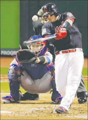  ?? AP/CHARLIE RIEDEL ?? Cleveland Indians’ Roberto Perez hits a home run against the Chicago Cubs in Game 1 of the Major League Baseball World Series on Tuesday in Cleveland.