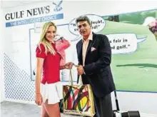  ?? Ahmed Ramzan/Gulf News ?? Adding the cool factor Rajeev Khanna, Commercial Director — Gulf News, with Paige Spiranac at Gulf News’ chalet at Emirates Golf Club.