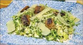  ?? The Associated Press ?? Brussels sprouts Caesar salad with sardine croutons. This fresh and healthy spin on a Caesar salad uses Brussels sprouts instead of romaine, a little mayo instead of raw egg.