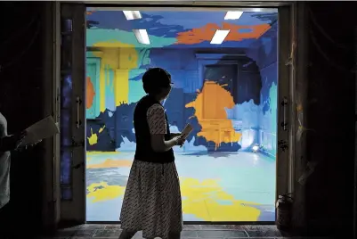  ??  ?? Splashes of color attract a visitor to one of the rooms at the Shanghai Workers College of Medical Science yesterday during an exhibition before its renovation next month. — Jiang Xiaowei