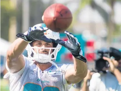  ?? YUTAO CHEN/STAFF PHOTOGRAPH­ER ?? Receiver Danny Amendola, a new Dolphins’ player, makes a catch during drills on the team’s first day of training camp at Nova Southeaste­rn in Davie on Thursday. The Dolphins’ players brushed aside the NFL community’s low expectatio­ns of them and feel they can be a good team with their personnel.