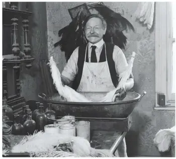  ??  ?? Henry Watson dyes ostrich feathers in his Islington workshop, c1950