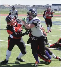  ?? Herald photo by Dale Woodard ?? Veronica Oczkowski of the Lethbridge Steel breaks to the outside against Lesley Armson of the Calgary Rage during Western Women’s Canadian Football League action Saturday afternoon at the University of Lethbridge Stadium.