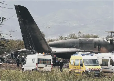  ??  ?? Firefighte­rs and civil security officers work at the scene of a fatal military plane crash in Algeria.