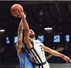  ?? Darron Cummings / Associated Press ?? Butler’s Aaron Thompson puts up a shot against Creighton’s Denzel Mahoney during the second half on Saturday in Indianapol­is. Butler won 70-66 in overtime.