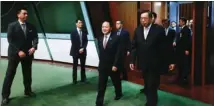  ??  ?? Liaison chief Wang Zhimin enters the Legislativ­e Council complex, accompanie­d by LegCo President Andrew Leung and other lawmakers.