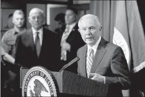  ?? AP/The El Paso Times/RUBEN R. RAMIREZ ?? Attorney General Jeff Sessions speaks to reporters Thursday after he and Homeland Security Secretary John Kelly (left) toured ports of entry in El Paso, Texas. On Friday, Sessions sent letters threatenin­g to cut funding to nine jurisdicti­ons that...