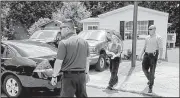  ?? AP/Atlanta Journal-Constituti­on/JOHN SPINK ?? Law enforcemen­t personnel gather Thursday at a home in Loganville, Ga., where members of a family were found dead.