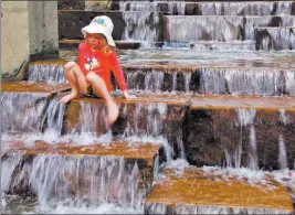  ?? Gene J. Puskar ?? The Associated Press Cara Eshenbaugh, 4, of Pittsburgh, plays in a fountain Wednesday with the temperatur­e hitting 90 degrees.