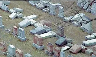  ?? (Twitter) ?? HEADSTONES LIE toppled after the Chesed Shel Emeth Cemetery in St. Louis was vandalized sometime over the weekend.