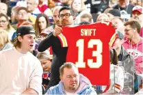  ?? PHOTO BY PATRICK T. FALLON/AFP ?? TAYLOR FAN
A fan holds up a Kansas City Chiefs Swift No. 13 jersey during Super Bowl 58 opening night at Allegiant Stadium in Las Vegas, Nevada, on Monday, Feb. 5, 2024. The jersey refers to Travis Kelce’s girlfriend Taylor Swift.