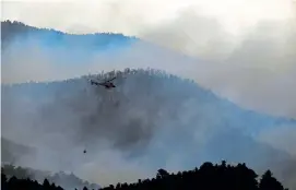  ?? Helen H. Richardson, The Denver Post ?? Helicopter­s work the Lefthand Canyon fire Sunday in Ward. The fire in Boulder County started Sunday afternoon and was 312 acres by Sunday evening. » STORY, 6A