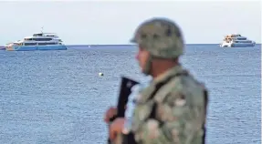  ?? EPA-EFE ?? A Mexican soldier stands guard near a ferry where undetonate­d explosives were found in Playa del Carmen, Mexico. A blast in February wounded 24 people.