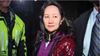  ??  ?? Huawei row: A TV image of Huawei Technologi­es’ CFO Meng Wanzhou as she exits the court registry following a bail hearing at British Columbia Superior Courts in Vancouver