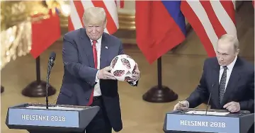  ??  ?? Russian President Vladimir Putin gives a football to US President Donald Trump during a press conference on July 16.