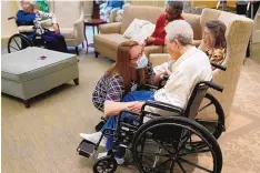  ?? JOHN BAZEMORE/ASSOCIATED PRESS ?? Naomi Adams checks on residents after they received the Pfizer COVID-19 vaccine at Monarch Villa memory care facility Monday in Stockbridg­e, Ga. All 26 residents of the home were to be vaccinated.