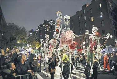  ??  ?? Revelersma­rch during the Greenwich Village Halloween Parade in New York on Oct. 31, 2019. The holiday somany look forward to each year is going to look different in the pandemic as parents and the people who provide Halloween fun navigate a myriad of restrictio­ns and safety concerns.