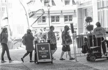  ?? TIM KROCHAK • THE CHRONICLE HERALD ?? People arrive at the walk-in vaccine clinic at the Convention Centre in Halifax on July 7.