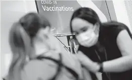  ?? JOHN LOCHER AP ?? Registered nurse Sofia Mercado gives a shot. Amazon launched its long-anticipate­d on-site vaccinatio­ns last month in Kansas, Missouri and Nevada.