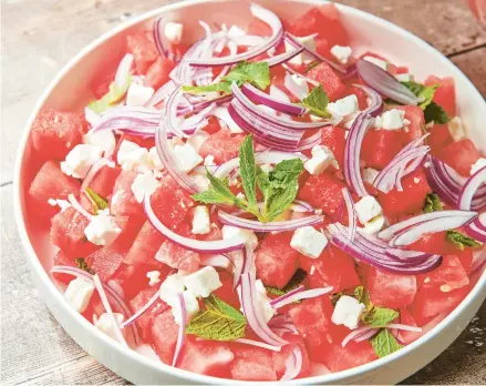  ?? CHEYENNE COHEN ?? Watermelon feta salad is topped with thinly sliced red onion and mint leaves.