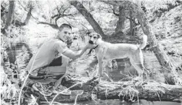  ?? FAMILY PHOTO ?? BILLY: In 2010, with the rescue dog given to him by Roxanne on his 22nd birthday. Scrap would follow Billy anywhere — into a canoe, across a stream, even up a tree.