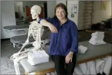  ?? CHARLES REX ARBOGAST — THE ASSOCIATED PRESS ?? April Oury, owner of Body Gears physical therapy center poses for a portrait with her instructio­nal skeleton George, in Chicago. Oury started her physical therapy practice 14 years ago wanting to give all aspects of her business the same focus and...