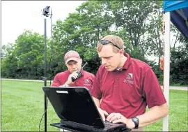  ?? PHOTO BY NORM SHAFER FOR THE WASHINGTON POST ?? Tombo Jones, left, and Robert Briggs of the Mid-Atlantic Aviation Partnershi­p set up the ground-control station before testing a drone for its ability to fly long distances.