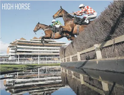  ?? Picture: Getty Images ?? Barry Geraghty (in green) riding Champ clears the water jump on his way to winning The KKA-Highpoint Beginners’ Chase at Newbury Racecourse in England.